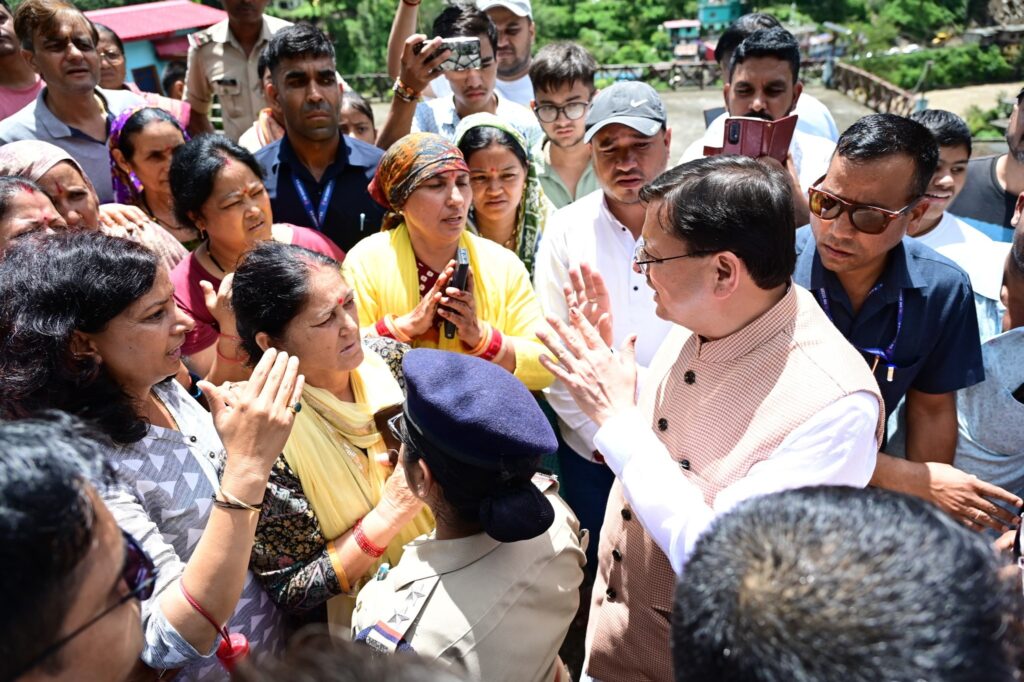 cm dhami with villagers