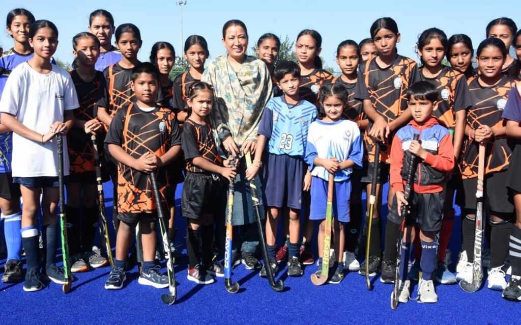 खेल मंत्री रेखा आर्या हल्द्वानी में हॉकी खिलाड़ियों के साथ खेलते हुए